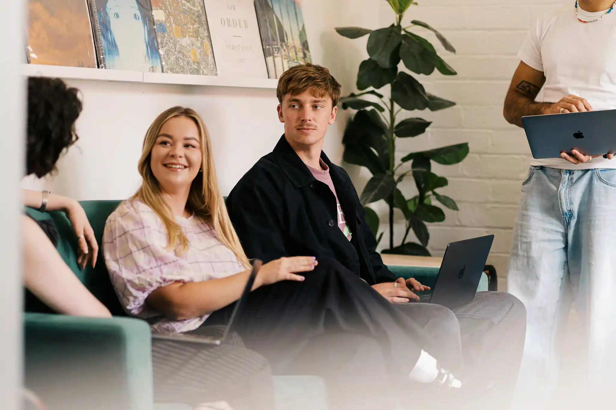 Three members of The Start team — two women and a colleague — smiling together in their office with plants in the background, January 2026